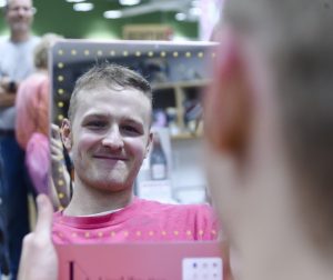 Employee cuts hair for breast cancer awareness